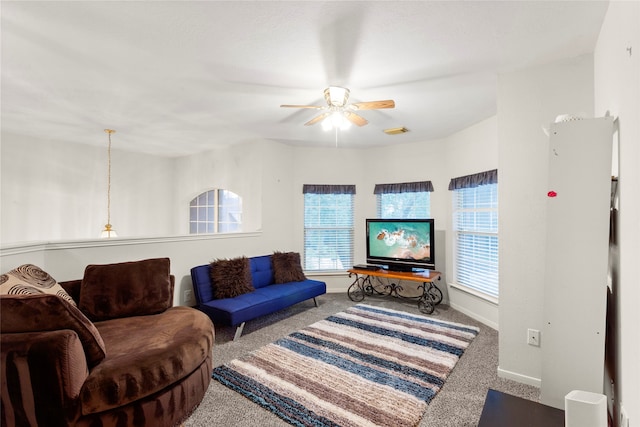 carpeted living room featuring ceiling fan