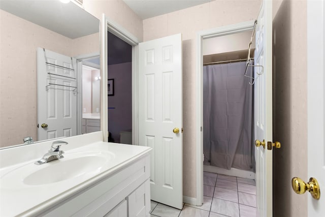 bathroom with tile patterned floors, walk in shower, and vanity