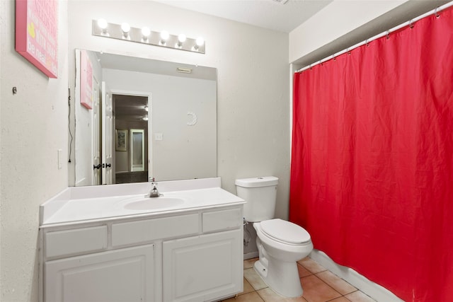 bathroom featuring tile patterned floors, vanity, and toilet