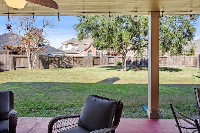 view of yard with ceiling fan and a patio area