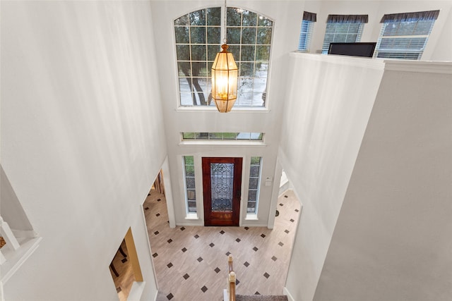 entrance foyer featuring an inviting chandelier and a high ceiling