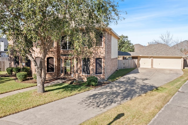 view of front of home with a front lawn and a garage