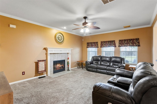 living room featuring ceiling fan, light colored carpet, ornamental molding, and a tiled fireplace