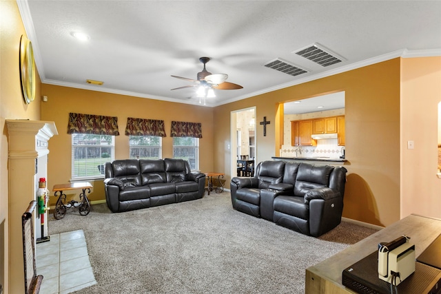 living room featuring ceiling fan, ornamental molding, and light carpet