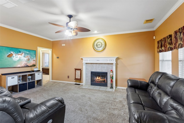 living room featuring ceiling fan, a fireplace, crown molding, and carpet flooring