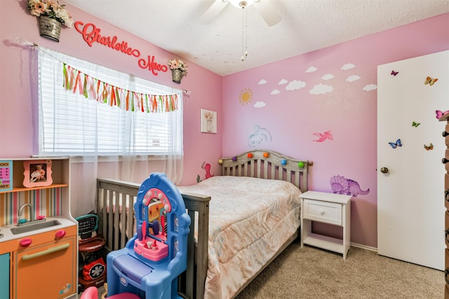 bedroom with a textured ceiling, ceiling fan, and light colored carpet