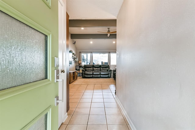 hall with light tile patterned floors