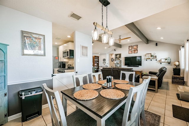 tiled dining area featuring vaulted ceiling with beams