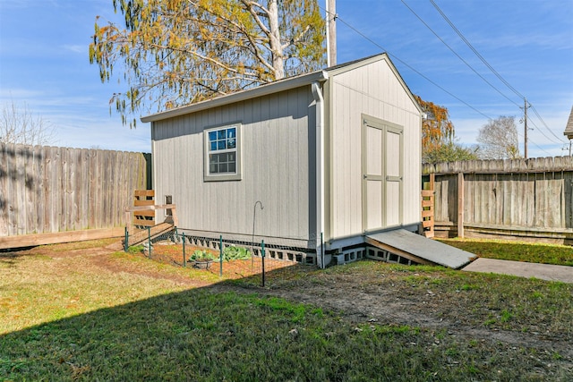 view of outbuilding featuring a lawn