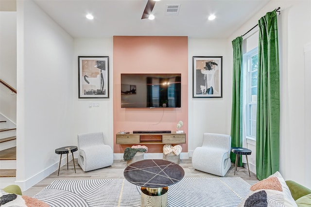 living room with light wood-type flooring and ceiling fan