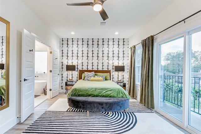 bedroom featuring ceiling fan, access to exterior, connected bathroom, and light hardwood / wood-style floors