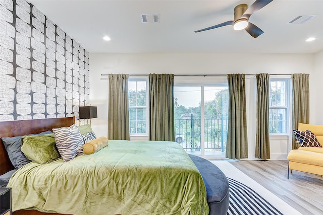 bedroom featuring hardwood / wood-style flooring, access to outside, and ceiling fan