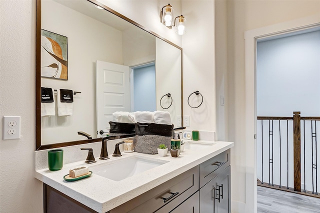 bathroom with hardwood / wood-style floors and vanity