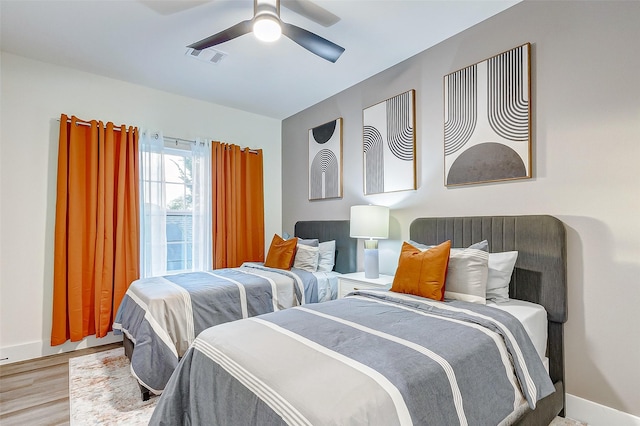 bedroom with ceiling fan and light hardwood / wood-style floors