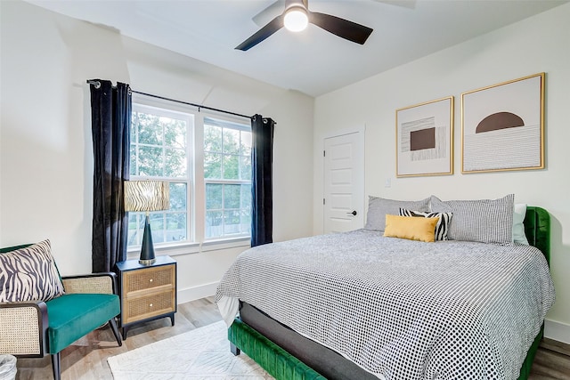 bedroom with ceiling fan and hardwood / wood-style flooring