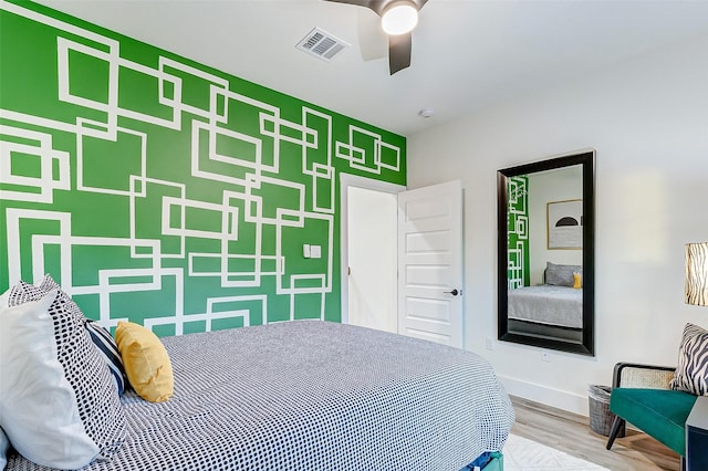 bedroom with ceiling fan and hardwood / wood-style floors