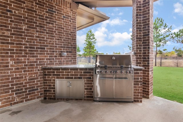 view of patio with grilling area and an outdoor kitchen