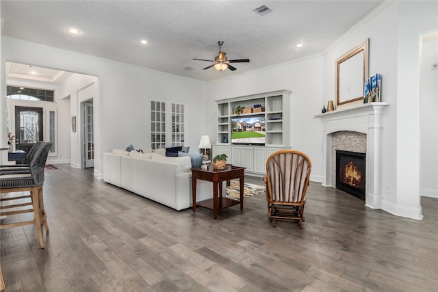 living room featuring ceiling fan, built in shelves, hardwood / wood-style flooring, and french doors