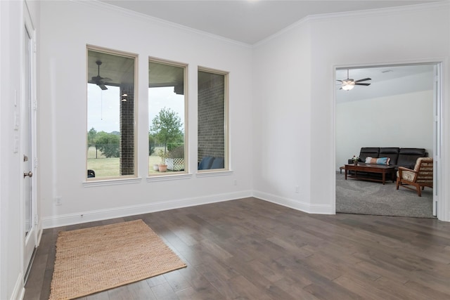 empty room featuring ceiling fan, dark hardwood / wood-style floors, and crown molding