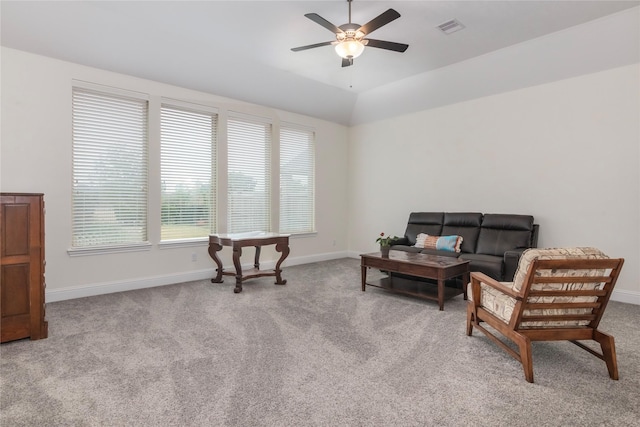 living area featuring vaulted ceiling, ceiling fan, and light carpet