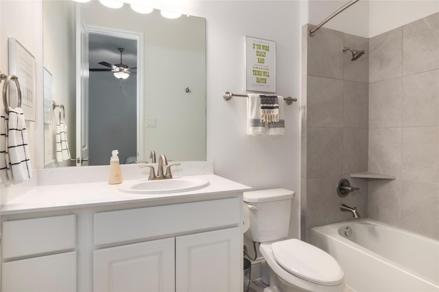 full bathroom featuring ceiling fan, tiled shower / bath combo, vanity, and toilet