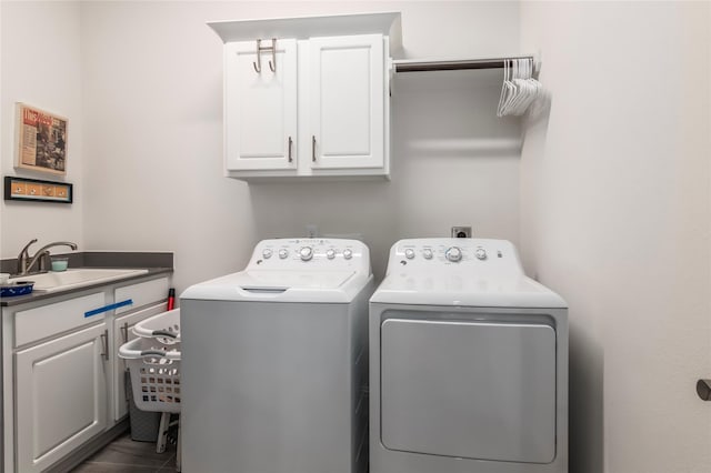 laundry room with cabinets, washer and clothes dryer, and sink