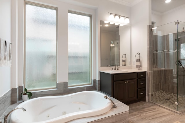 bathroom featuring ornamental molding, separate shower and tub, and vanity