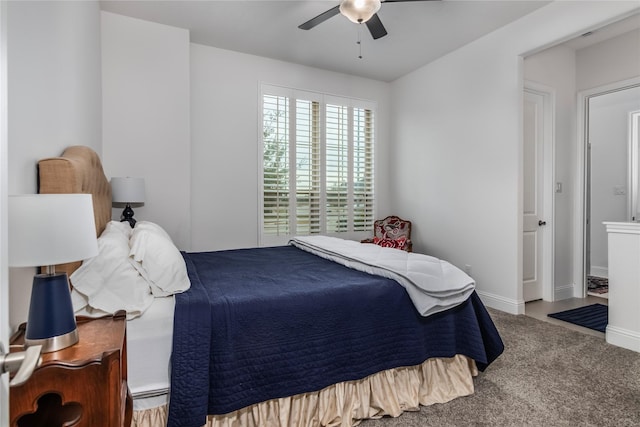 carpeted bedroom featuring ceiling fan and ensuite bath