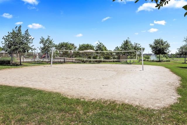 surrounding community featuring a lawn and volleyball court