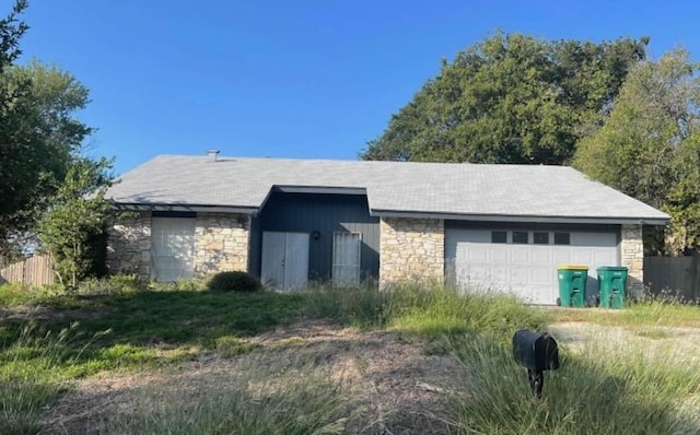 view of front facade featuring an outdoor structure and a garage