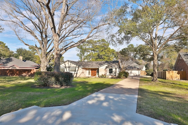 view of front of house with a front yard and a garage