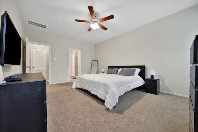 carpeted bedroom with ceiling fan and connected bathroom