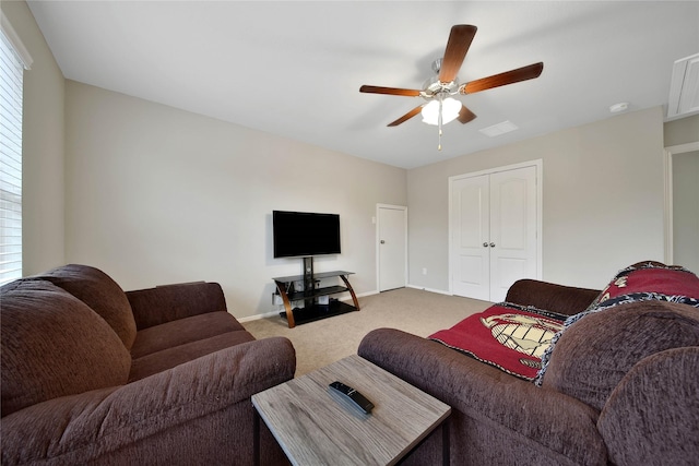 carpeted living room featuring ceiling fan