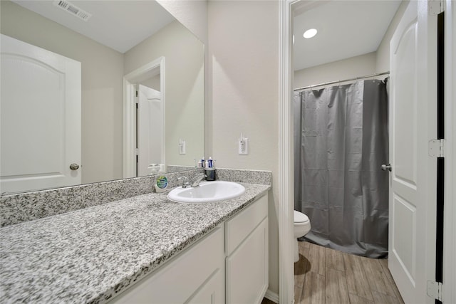 24715 Winema Woods Ln, Huffman, TX 77336 - full bathroom with visible vents, toilet, a shower with curtain, wood finished floors, and vanity