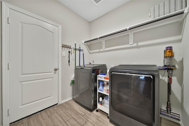 24715 Winema Woods Ln, Huffman, TX 77336 - washroom with visible vents, washer and dryer, light wood-style floors, baseboards, and laundry area