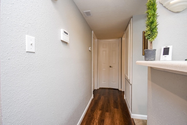 hallway with dark wood-type flooring