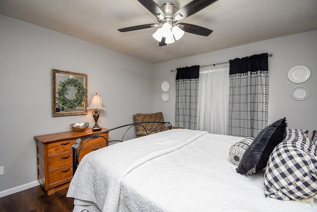 bedroom with ceiling fan and dark hardwood / wood-style flooring