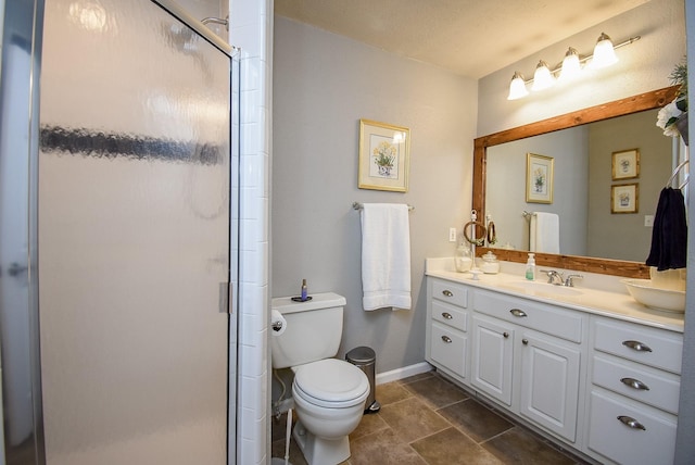 bathroom featuring toilet, a textured ceiling, an enclosed shower, and vanity