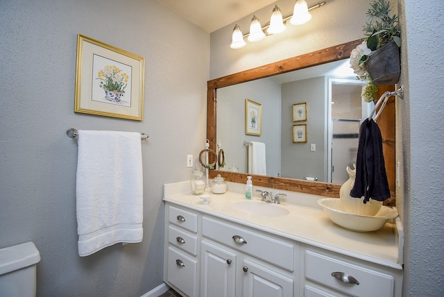 bathroom with toilet and vanity