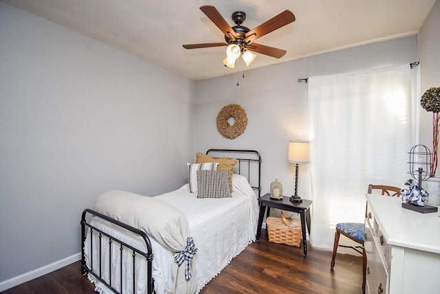 bedroom with ceiling fan and dark hardwood / wood-style flooring