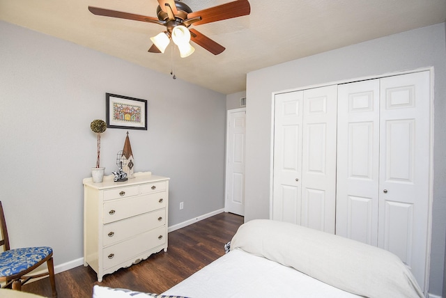 bedroom featuring ceiling fan, a closet, and dark hardwood / wood-style flooring