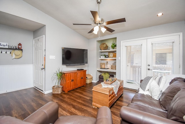 living room featuring built in shelves, dark hardwood / wood-style flooring, french doors, vaulted ceiling, and ceiling fan