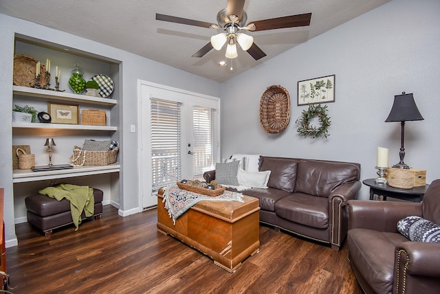 living room featuring built in shelves, french doors, dark hardwood / wood-style floors, vaulted ceiling, and ceiling fan