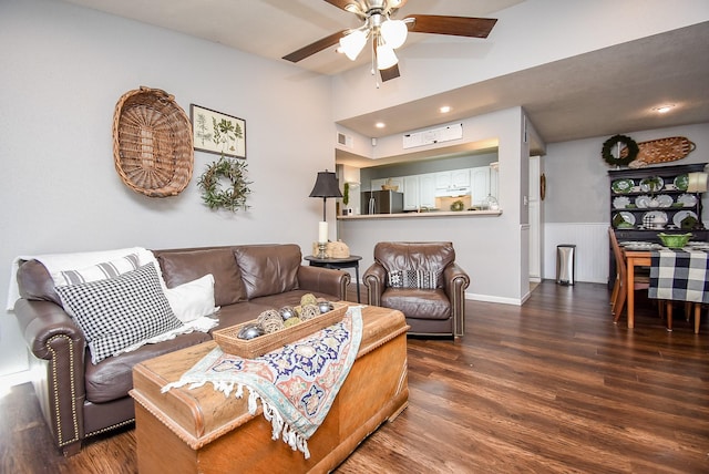 living room featuring ceiling fan and dark hardwood / wood-style floors