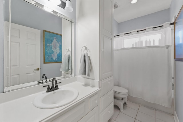 bathroom featuring tile patterned floors, vanity, and toilet