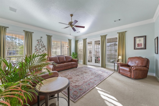 living room with a healthy amount of sunlight, french doors, and ornamental molding