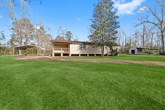 rear view of property featuring a lawn and a carport