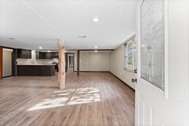 interior space with light hardwood / wood-style floors and sink