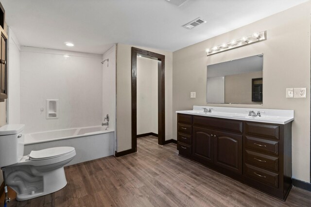 full bathroom with toilet, vanity, shower / washtub combination, and hardwood / wood-style floors