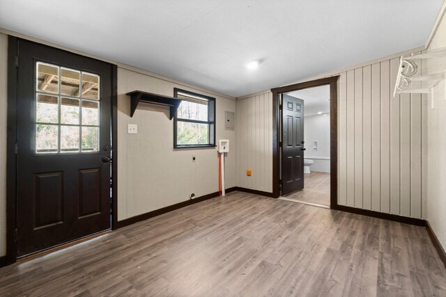 entryway with wood-type flooring and wood walls